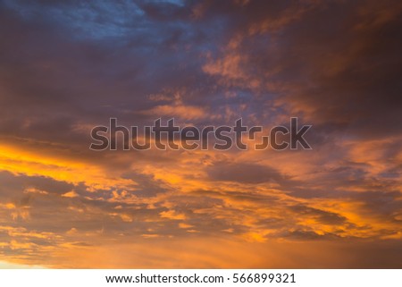 Sky with gold clouds - dramatic sunset, beautiful natural background. Setting sun illuminates the clouds. 