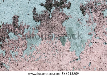 The texture of the cladding cement plaster pink, damaged with signs of mold.