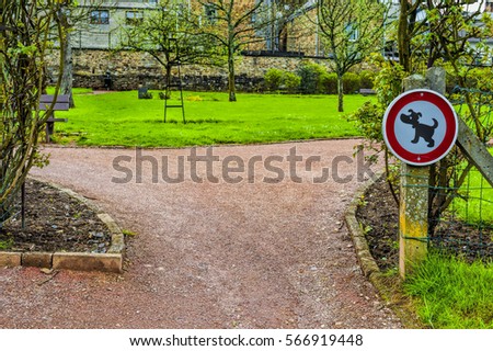 The sign prohibiting walking dogs in a park in Belgium. A sign telling you that this is not a dog toilet area.