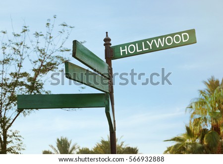 Street sign with word HOLLYWOOD on sky background