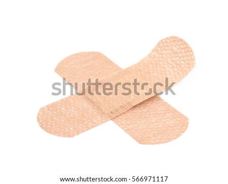 Cross shaped adhesive bandage sticking plaster isolated over the white background