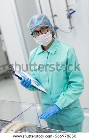 look at camera, close look of scientist in big glasses and med suit