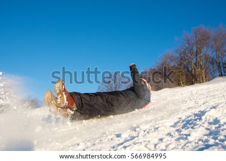 Girl falling down on the snowy mountain