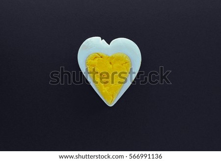 Egg heart on black background. Romantic background concept