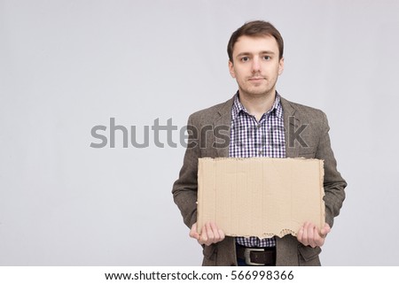 Business man holding a banner - isolated over a white background. man holding a sign with cardboard