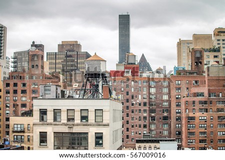 Modern and old buildings of New York as seen from rooftop.