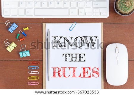 Text Know the rules on white paper which has keyboard mouse pen and office equipment on wood background / business concept.