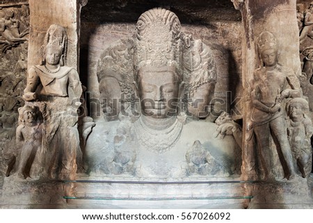 Trimurti sculpture inside the Elephanta Island caves near Mumbai in Maharashtra state, India Royalty-Free Stock Photo #567026092
