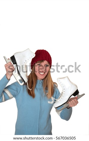Smiling girl showing shoes for winter ice skating sport