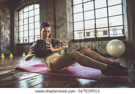 Woman training with functional gymnastic in the gym Royalty-Free Stock Photo #567039013