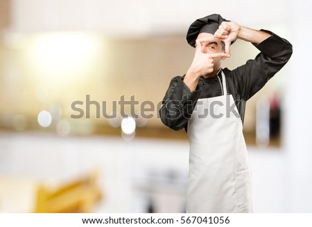 Surprised chef taking a photo