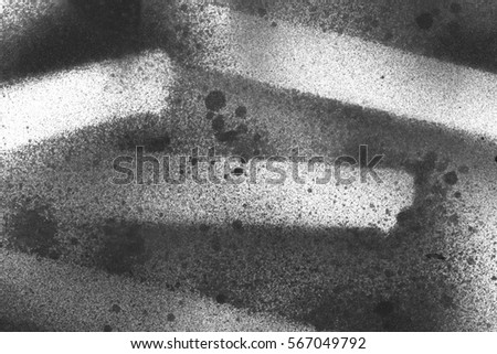 Abstract graffiti background. Wallpaper with airbrush effect. Black acrylic paint stroke texture on white paper. Scattered mud art. Macro image of spray paint. Hand made grunge backdrop.
