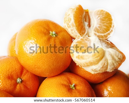 Ripe slice of mandarin citrus fruit on white background close up , selective focus