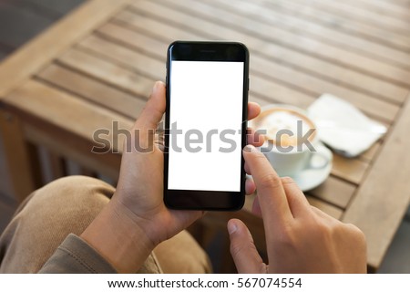 close-up hand holding phone mobile blank screen and finger touching in coffee shop