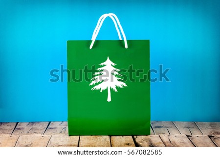 Green Paper Bag with icon tree on blue background.