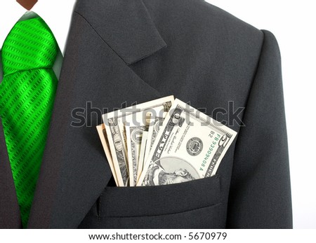 A businessman with dollar notes in his suit pocket