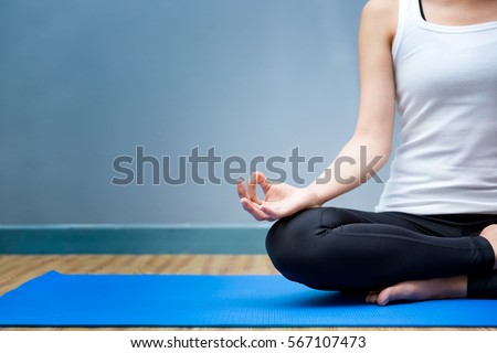Young woman meditates while practicing yoga. Yoga concept, Calmness and relax, woman happiness.  Royalty-Free Stock Photo #567107473