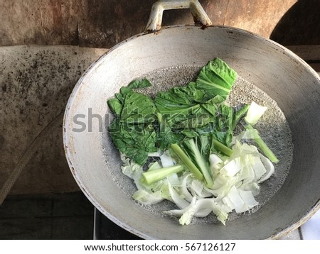 Green Vegetables and cooking in the boiling water in the metal a pan on the stove