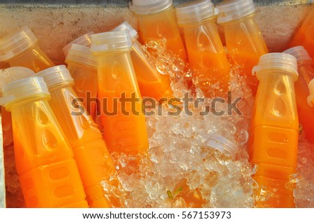 orange juice bottles Royalty-Free Stock Photo #567153973