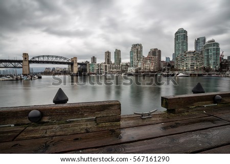 View of Burrard Bridge and Vancouver Downtown from Granville Island, False Creek, BC, Canada. Picture taken during a rainy winter day.
