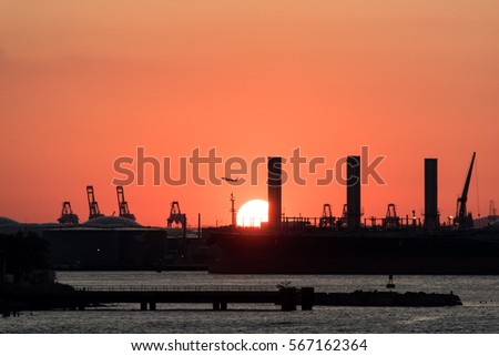 Beautiful sunset with silhouette city background and airplane taking off