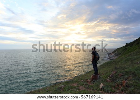 Man standing at Khao Laem Ya beach and sunset in Rayong ,Thailand