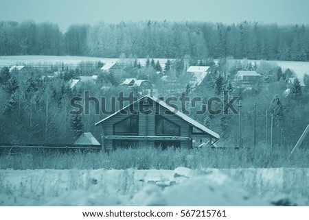 rural landscape with small houses on a snowy day