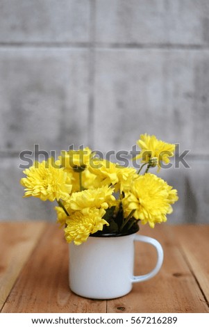 Cup with yellow Chrysanthemum