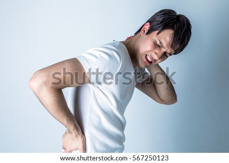 young man having a pain in his neck and low back