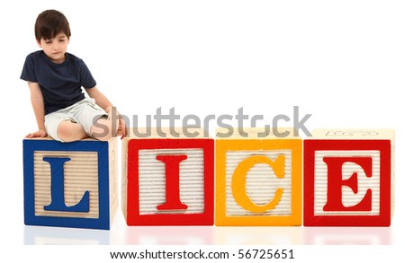 Attractive seven year old french american boy sitting on giant word lice.