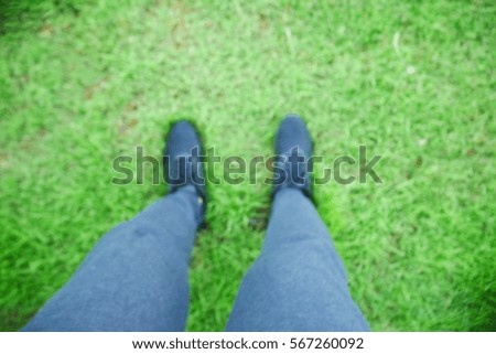 Picture blurred  for background abstract and can be illustration to article of people standing on grass