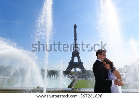 groom and bride in Paris near a splashing fountain