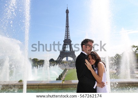 groom and bride in Paris near a splashing fountain