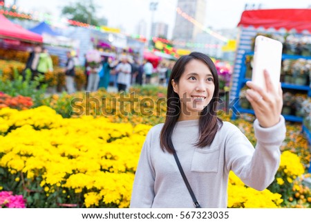 Woman taking selfie in Lunar new year market