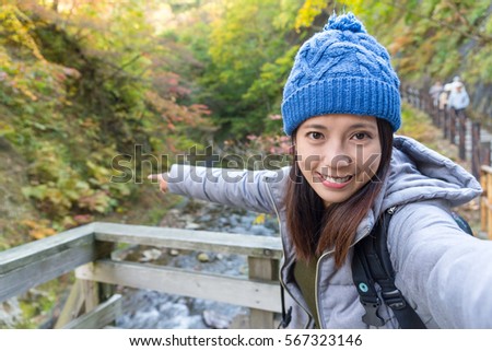 Woman taking selfie when hiking in forest
