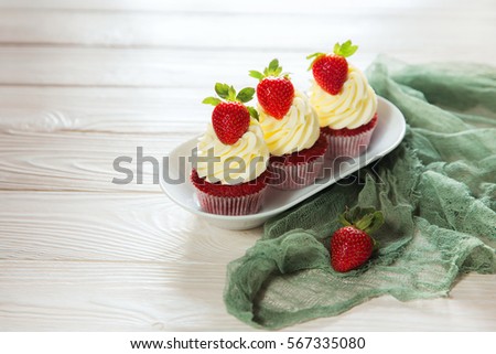 Muffins red velvet with cheese cream and strawberry selective focus