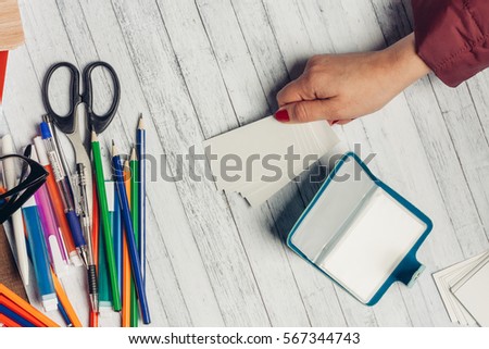 pencils, pens, business cards, visiting cards business card in hand