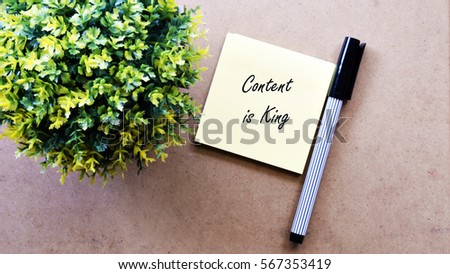 Green tree, sticky note with text Content is King!