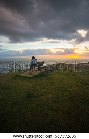 Young Girl watching sunrise.