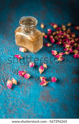 Dry tea rose buds on dark blue background. 
