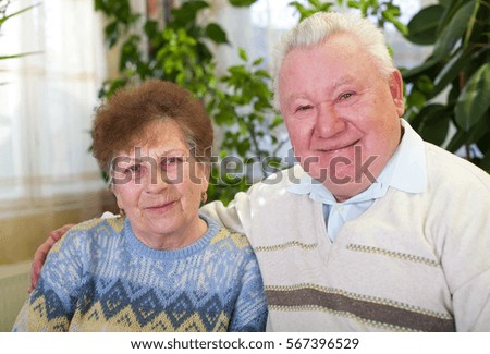 Picture of a joyful elderly couple at home
