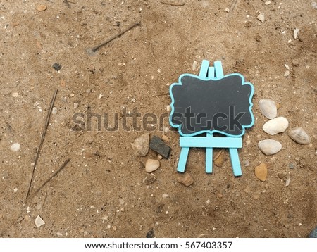 Plain chalk board on the sand