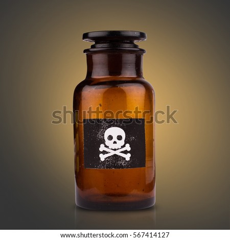 front view of brown medical glassware with glass cap and the poison sign label on dark background Royalty-Free Stock Photo #567414127