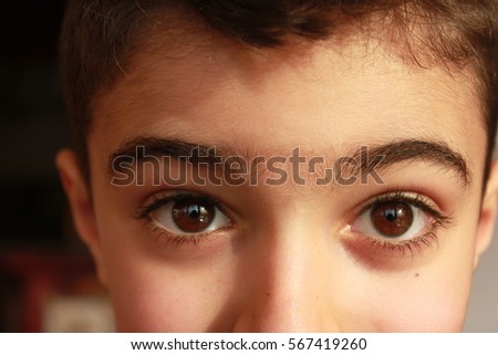 Italy, beautiful brown eyes of a child Royalty-Free Stock Photo #567419260
