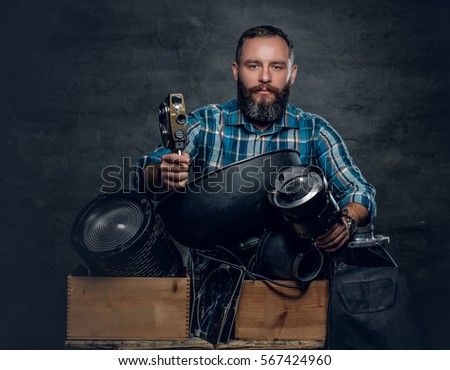 Portrait of middle age man videographer in a studio.