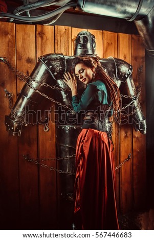 A beautiful woman embracing male robot with love. Relationship between artificial cyborg and real girl. Portrait of futuristic couple.