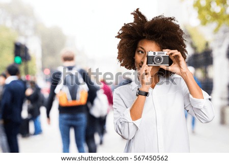 young black woman using a vintage camera