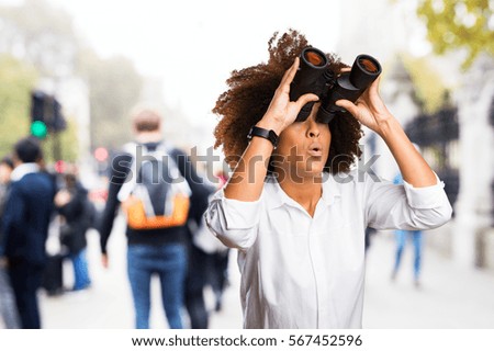 young black woman looking through the binoculars