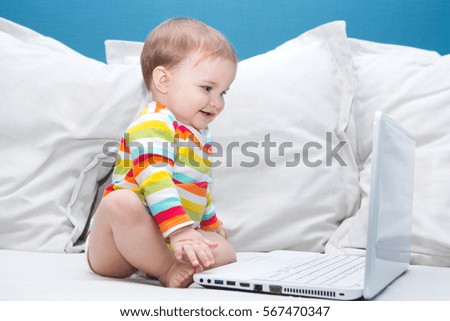 baby playing computer at home
