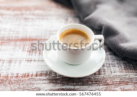 Cup of coffee on a wooden table.